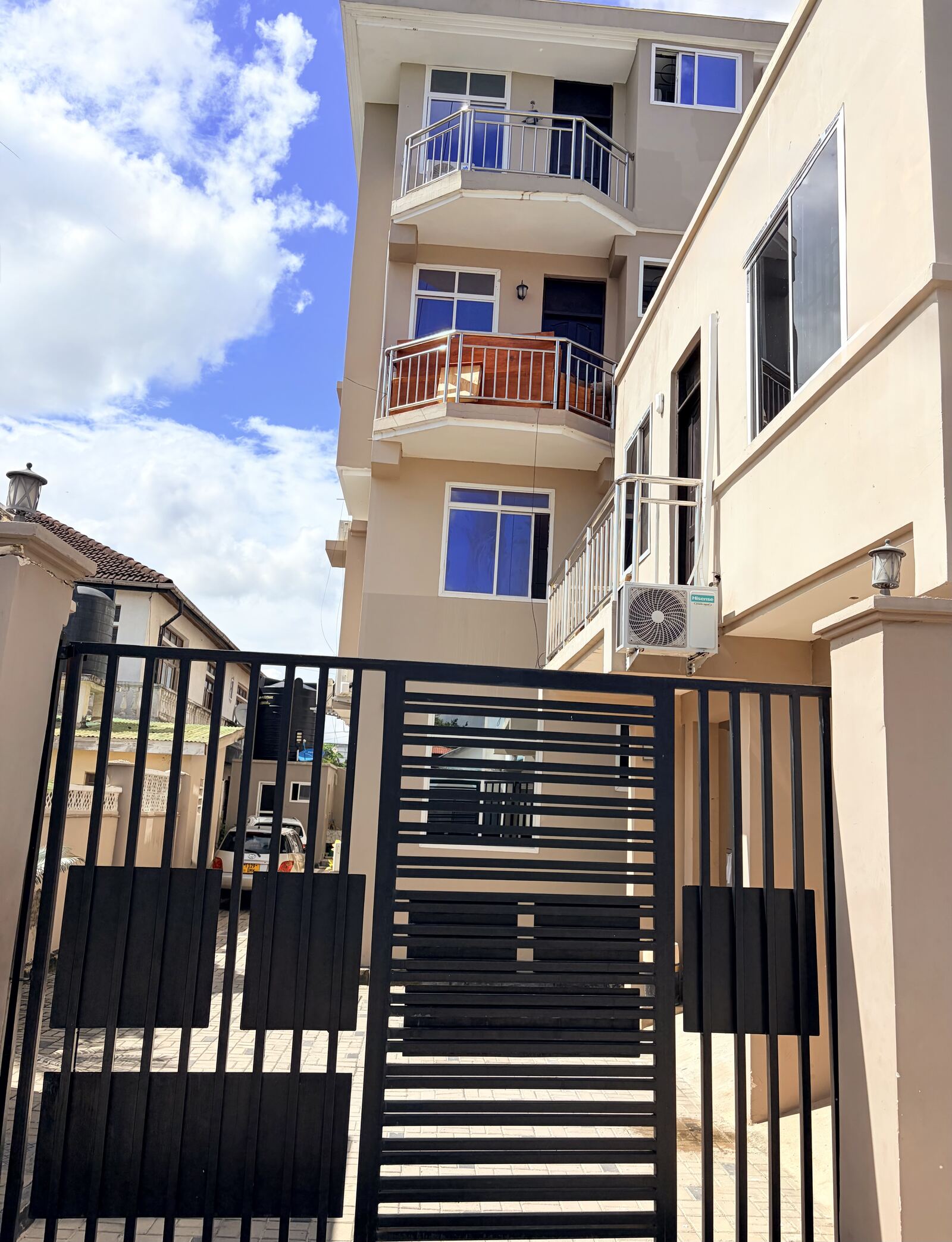 Exterior of the Mikocheni apartment building with balconies and gated entrance