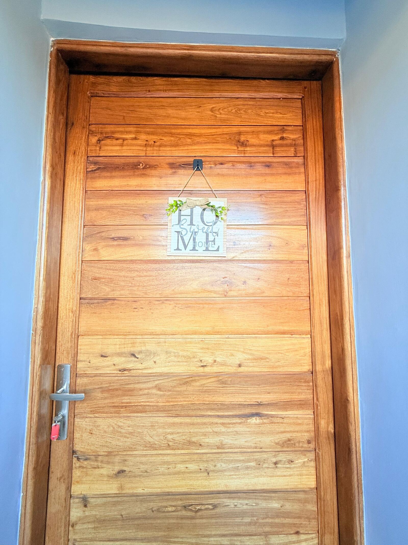Sinza wooden entrance door with Home sign