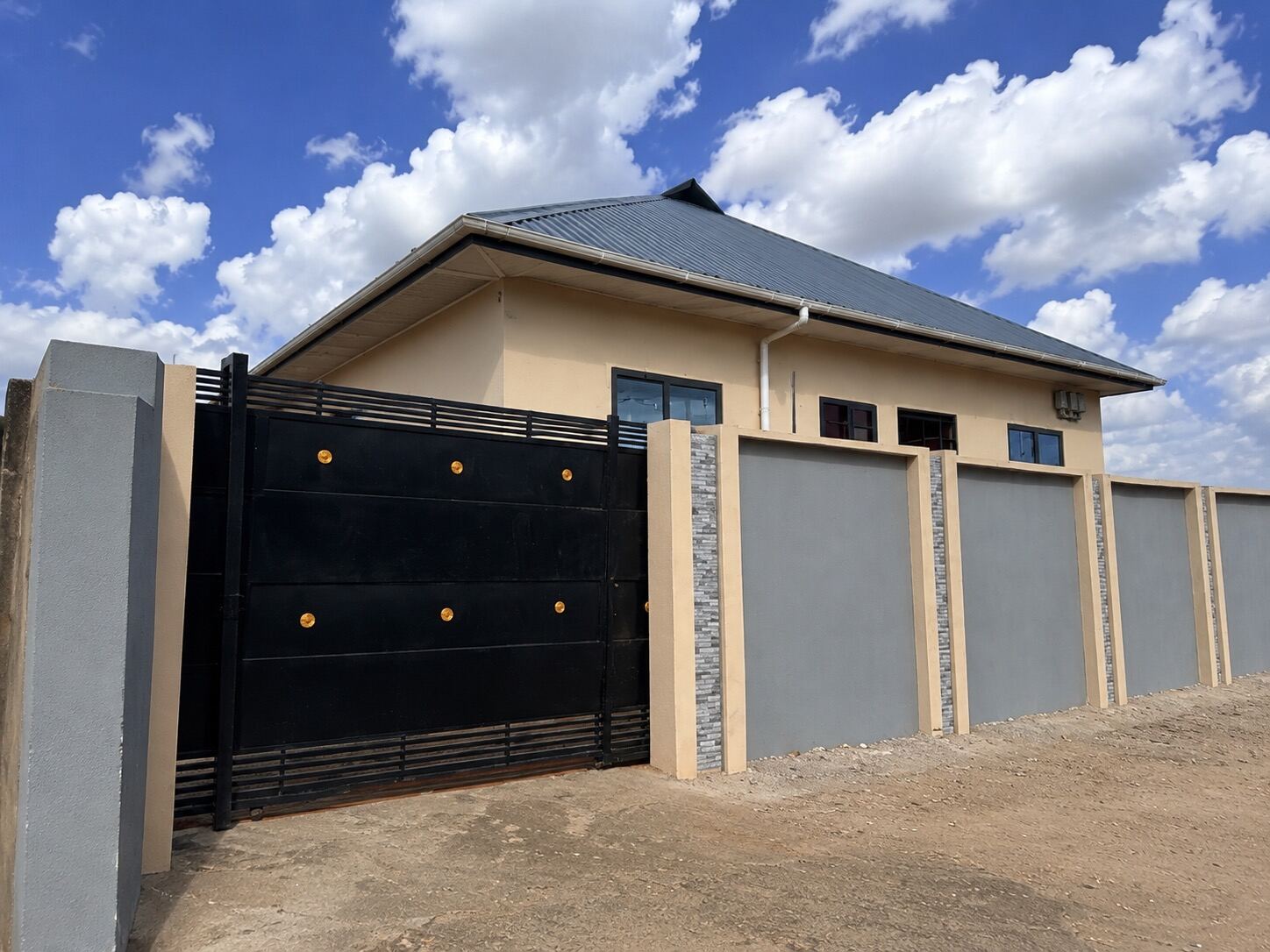 Exterior of the Sinza apartment, a gated single-storey home