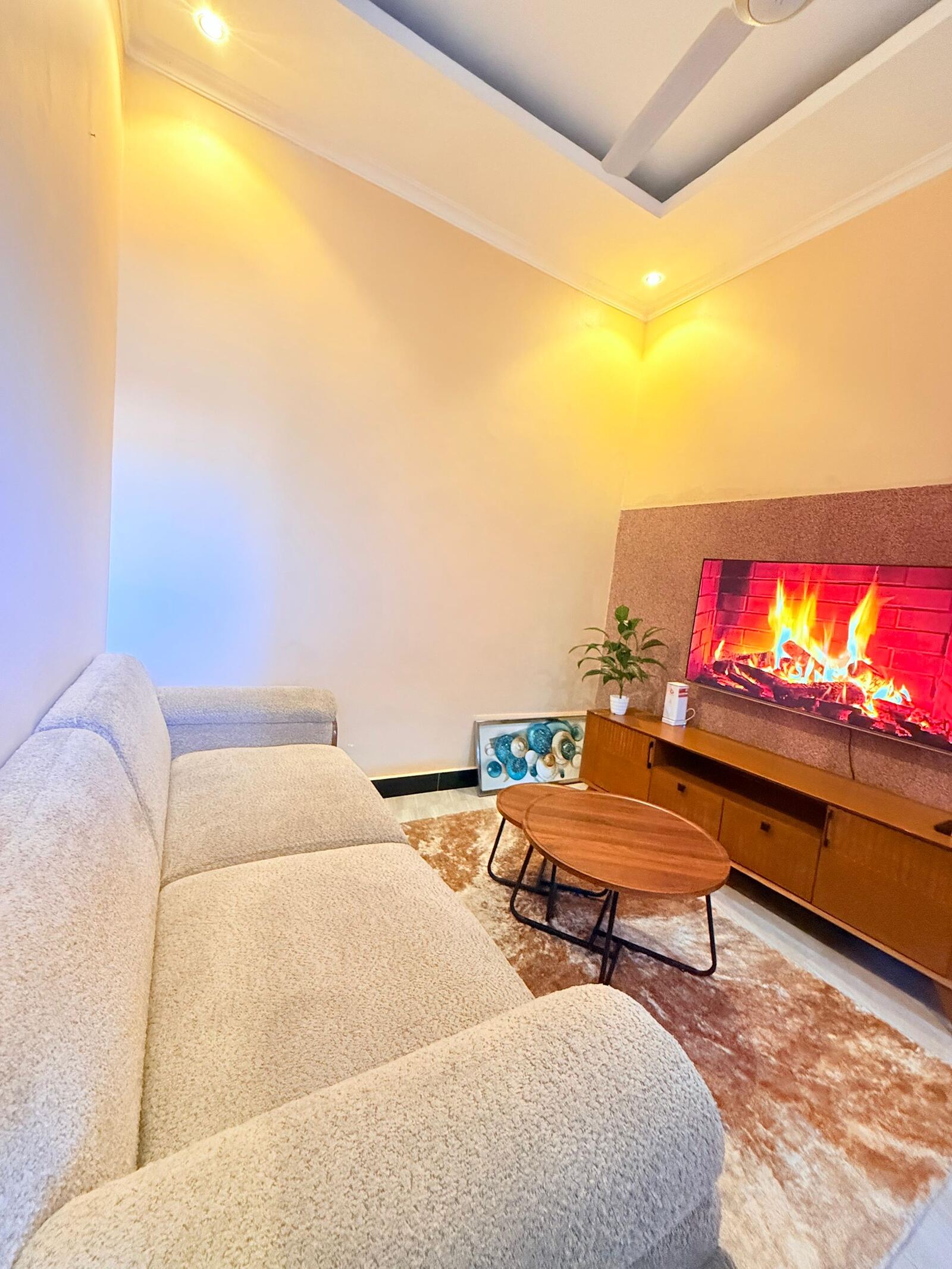 Sinza living room with cream sofa and TV